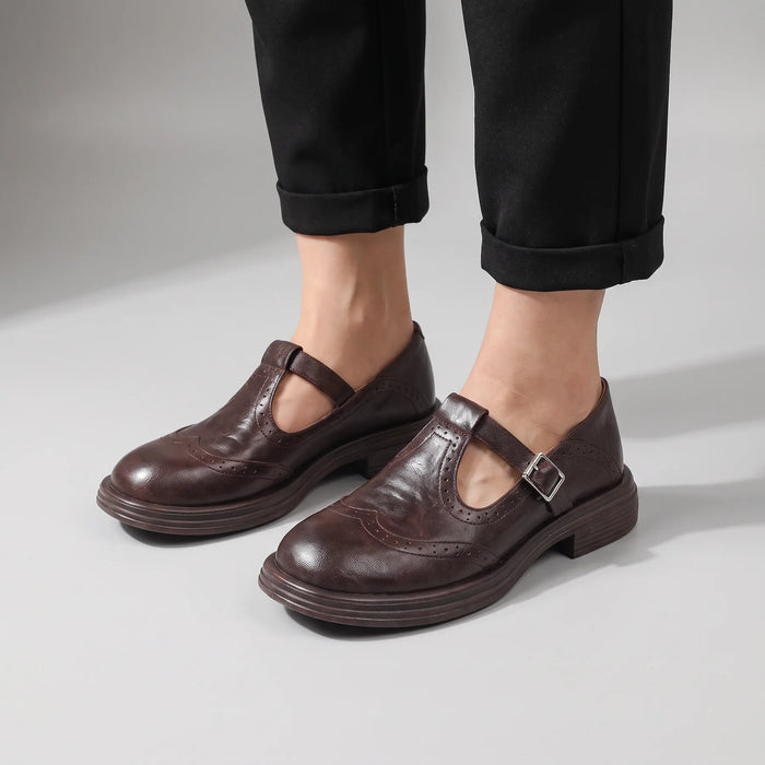 Brown Women's Mary Jane Pumps with Brogue Detailing & Buckle Strap - Front Worn Black Pants