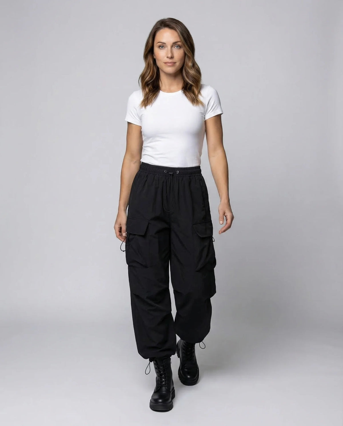 Black Women's Oversized Cargo Pants with Drawstring Waist & Flap Pockets — Layla - Model Walking Front
