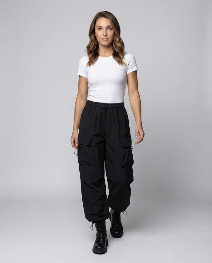 Black Women's Oversized Cargo Pants with Drawstring Waist & Flap Pockets — Layla - Model Walking Front