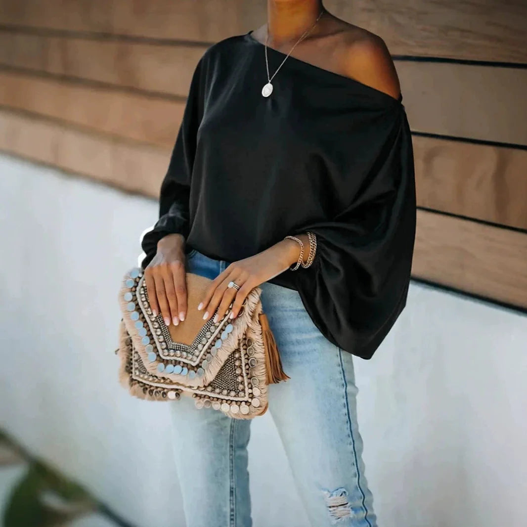 Black Women's Satin Blouse with Asymmetric Off-Shoulder Neckline & Batwing Sleeves - Front Full With Clutch