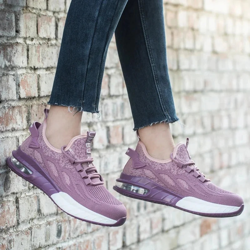 Purple Women's Steel Toe Sneakers with Air-Cushioned Sole & Breathable Mesh Upper - Worn Lifestyle Brick Wall